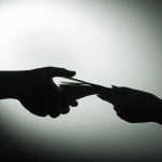 hands exchanging cash