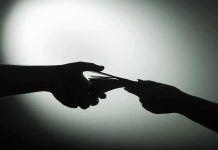 hands exchanging cash