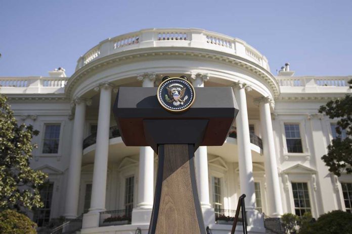 Press podium with presidential seal in front of the White House