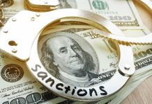 Handcuffs on U.S. hundred-dollar bills