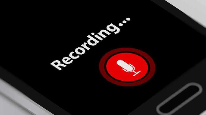 shutterstock_1179698311 smartphone screen showing a red microphone recording button