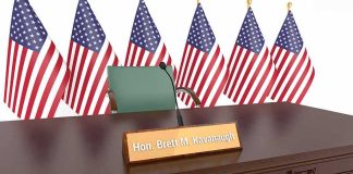 nameplate on a hearing table with microphone and flags