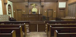 Anti-Christ Claim Shocks Illinois Case Interior view of an empty courtroom with wooden benches and a judges bench