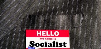 Socialist Says Getting FIT Helps the Fascists Name tag on a pinstripe suit jacket pocket