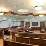 Did the Internet Decide Clancy’s Case BEFORE the Jury? Empty courtroom with wooden benches and judge's bench