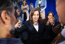Kamala Harris speaks to a crowd as Maya Harris stands nearby