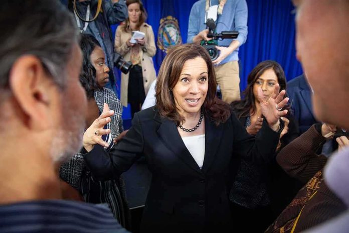 Kamala Harris speaks to a crowd as Maya Harris stands nearby