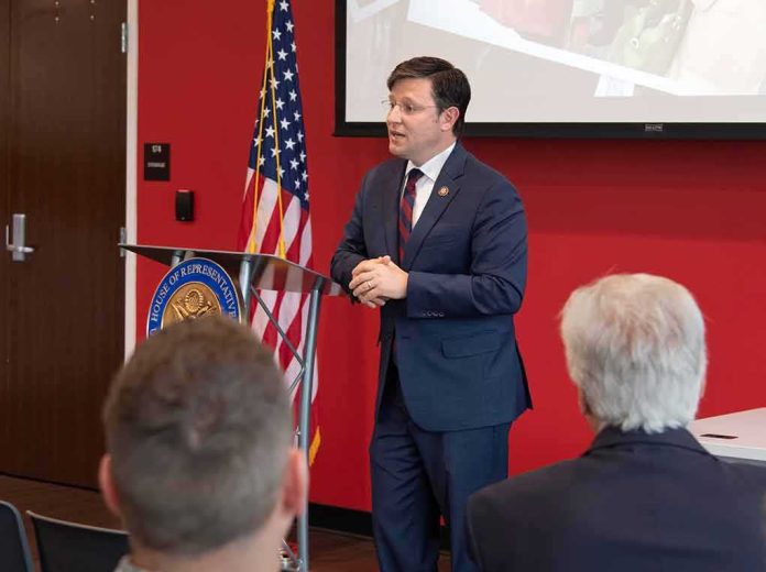 Speaker in a navy suit addressing an audience at a podium