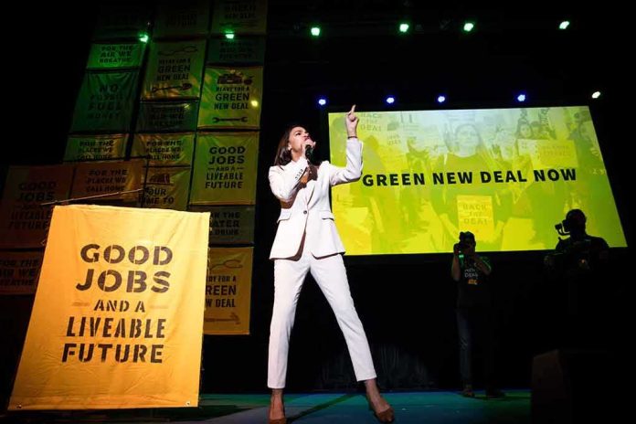 shutterstock_1398680729 Speaker in white suit on stage at climate rally
