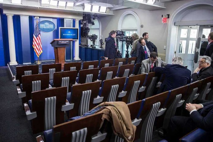 shutterstock_1465699346 White House press briefing room with empty seats and cameras