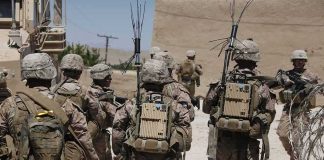 soldiers in desert fatigues with radio packs and antennas