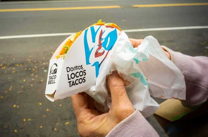shutterstock_1545877553 Hands holding a Taco Bell Doritos Locos Tacos