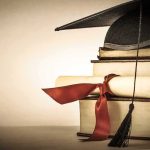Law Schools’ Power Grip Threatened—Aid At Risk Graduation cap and diploma on stacked books