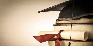 Graduation cap and diploma on stacked books