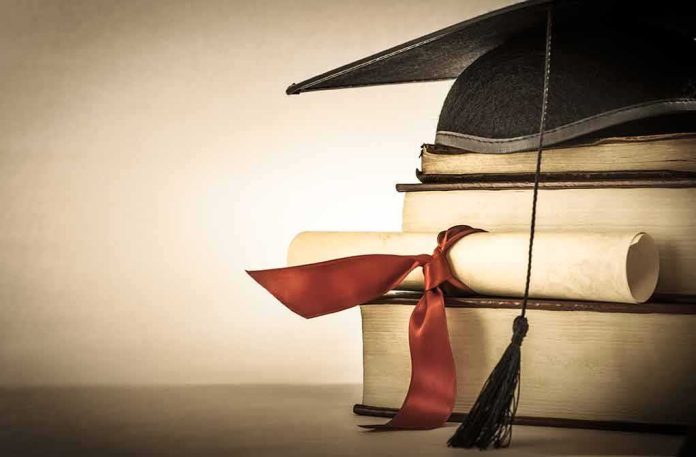 shutterstock_155347391 Graduation cap and diploma on stacked books