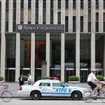 News Corporation building entrance with NYPD car and cyclists