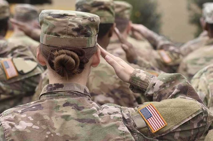 shutterstock_1711680580 U.S. soldiers in camouflage uniforms saluting