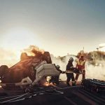 Firefighters at overturned car crash scene at sunset