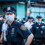 Chicago Democrat TURNS on Mayor Over Crime Police officer in mask among colleagues at a city street gathering