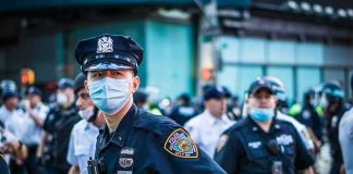 Chicago Democrat TURNS on Mayor Over Crime Police officer in mask among colleagues at a city street gathering