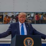‘Help Iran and Pay the Price,’ Trump Warns Donald Trump speaks at a podium with arms outstretched