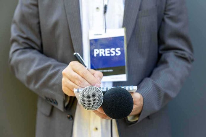 Journalist holding notebook and microphones