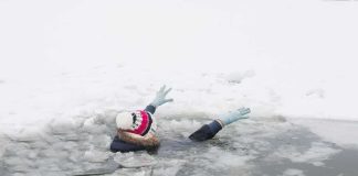 person fallen through ice raising gloved hands