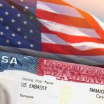 200,000 Visas Could Be on the Chopping Block US visa document with American flag in background