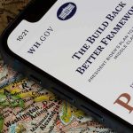 Trump Rolls Out BIGGEST Election Watchdog Force in US History! Smartphone showing a government webpage on a paper map