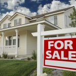 Grant Cardone Torches Homeownership Right Now A suburban house with a For Sale sign in the front yard