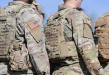 U.S. soldiers in camouflage uniforms with tactical vests