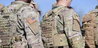U.S. soldiers in camouflage uniforms with tactical vests