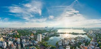 Aerial view of a city with a large lake at sunset