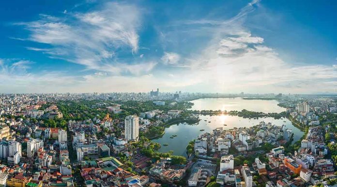 Aerial view of a city with a large lake at sunset