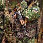 soldier in camouflage holding a rifle