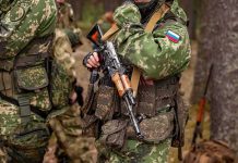 soldier in camouflage holding a rifle