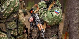 Russia Exploits Muslim Jihad in Ukraine soldier in camouflage holding a rifle