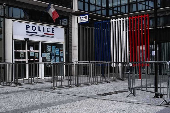 shutterstock_2273264877 Police station entrance with barriers and French flag colors
