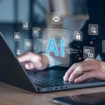 Claude Was Caught Helping Build Weapons Hands typing on laptop with AI and tech icons overlay