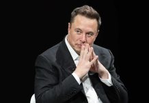 man in a suit with hands clasped thoughtfully