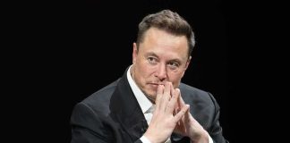 Elon Musk Joins AI Slowdown! man in a suit with hands clasped thoughtfully