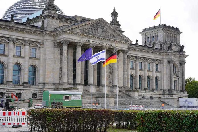 shutterstock_2373045547 Reichstag building with flags in front