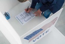 Voter filling out a ballot in a private voting booth