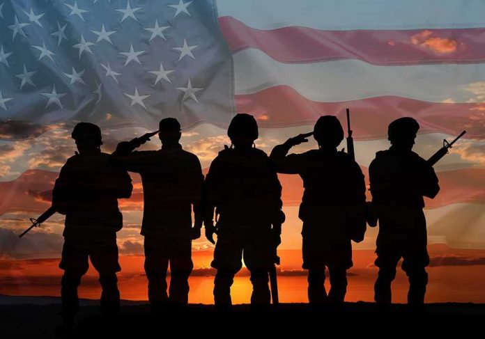 shutterstock_2441037953 Soldiers saluting at sunset with American flag overlay
