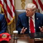 Donald Trump speaks at a meeting beside Marco Rubio at a conference table