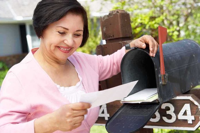 Woman checking mail at a roadside mailbox