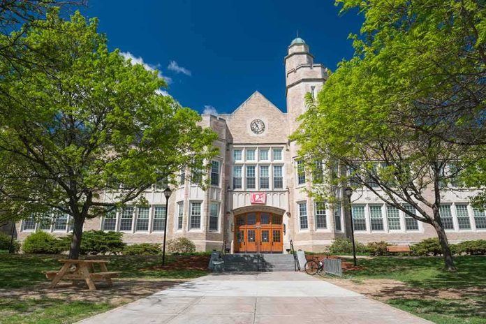 Historic academic building with clock tower framed by green trees