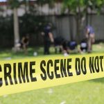 crime scene tape cordoning off a grassy area