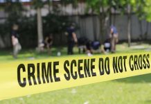crime scene tape cordoning off a grassy area
