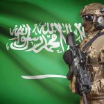 Saudi Arabia, Turkey and Pakistan Sign Joint Defense Pact Soldier in tactical gear stands before a green flag